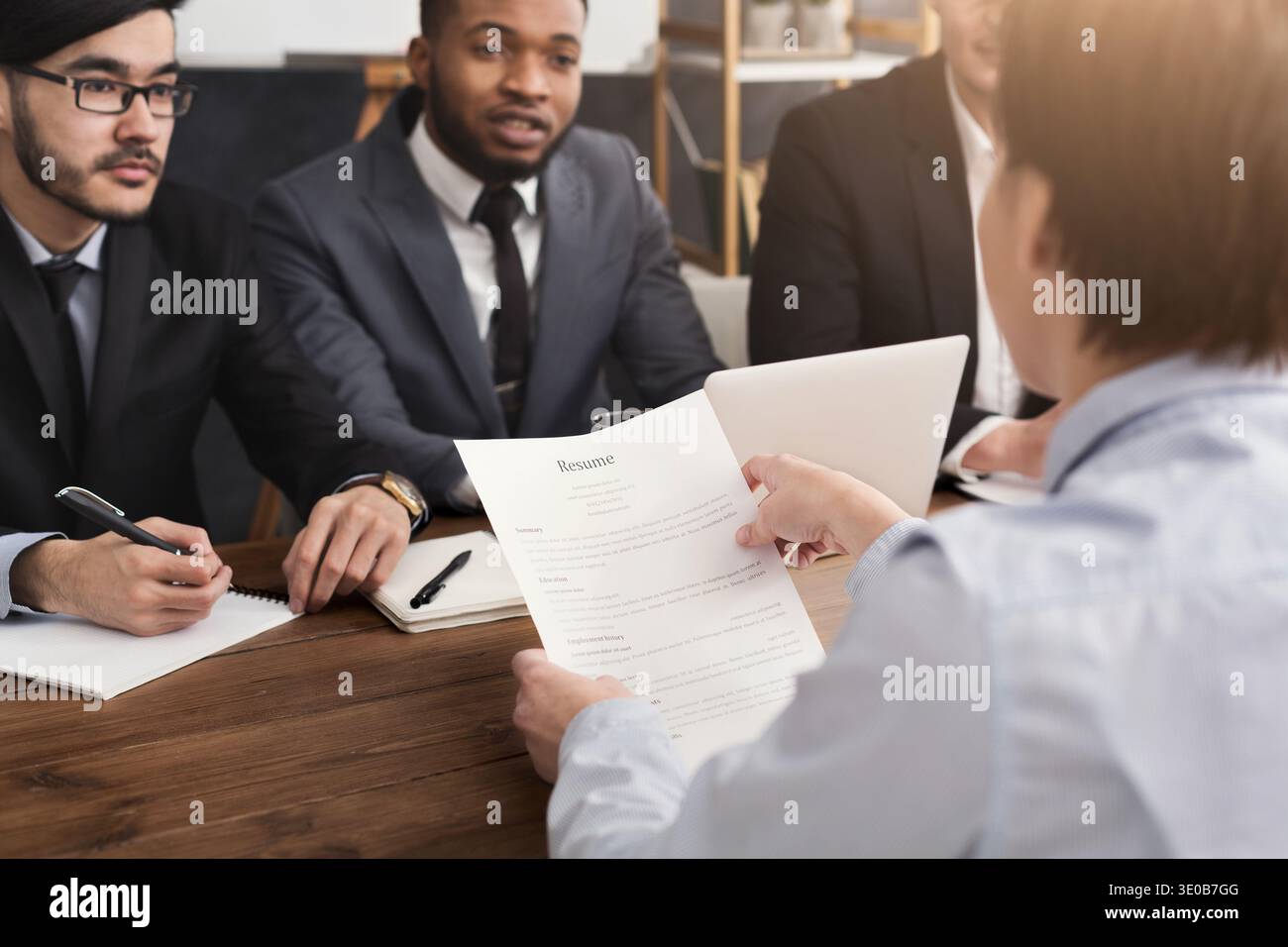 Female candidate holding resume during interview Stock Photo