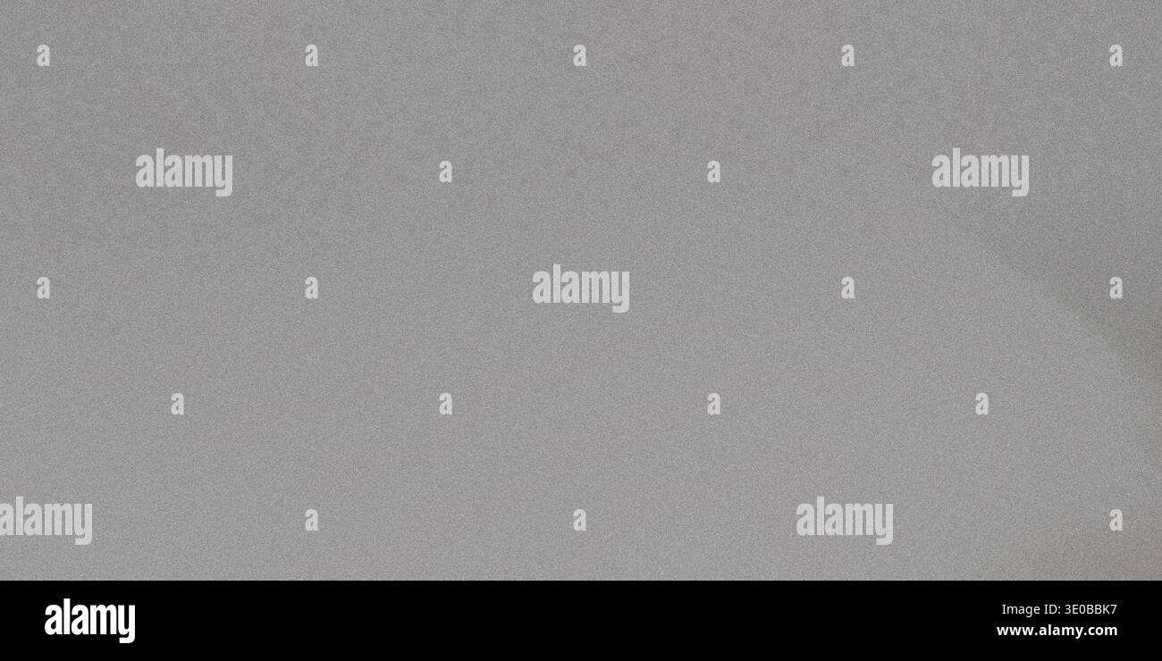 A subtle gray grainy texture creates a versatile abstract background with a rough, vintage feel Stock Photo
