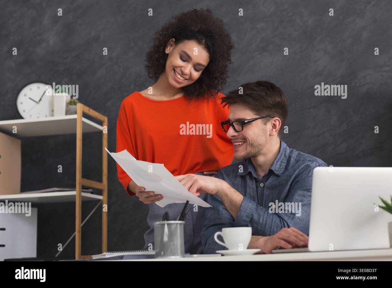 Couple of young colleagues work at modern office Stock Photo