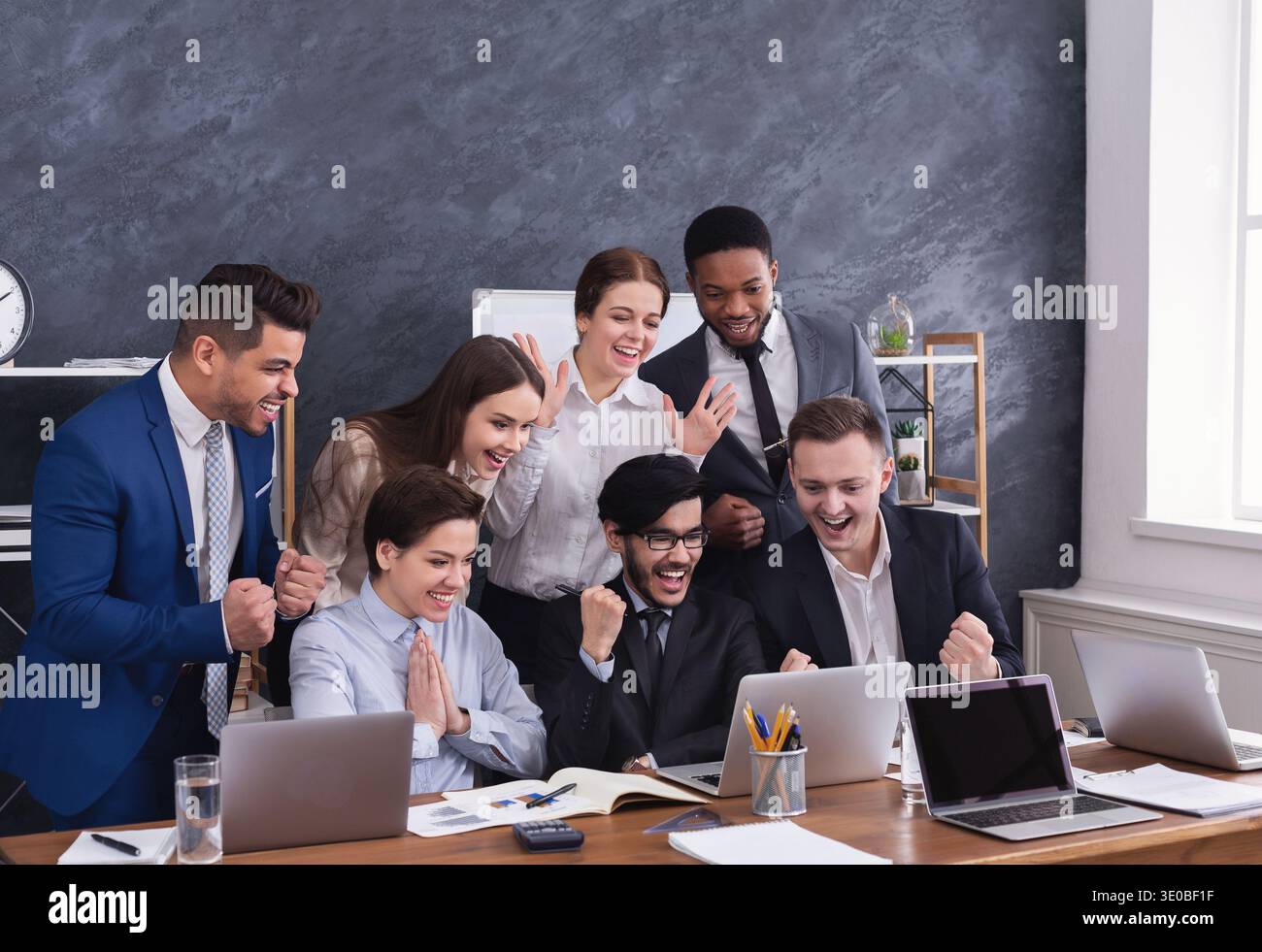Happy multiracial managers successfuly completed hard project Stock Photo