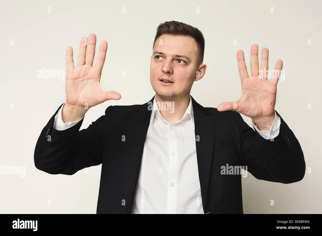 Young businessman using virtual screen for work Stock Photo