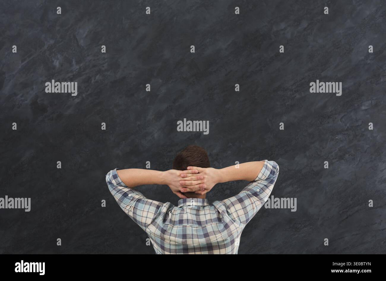Young relaxed man in studio back view Stock Photo