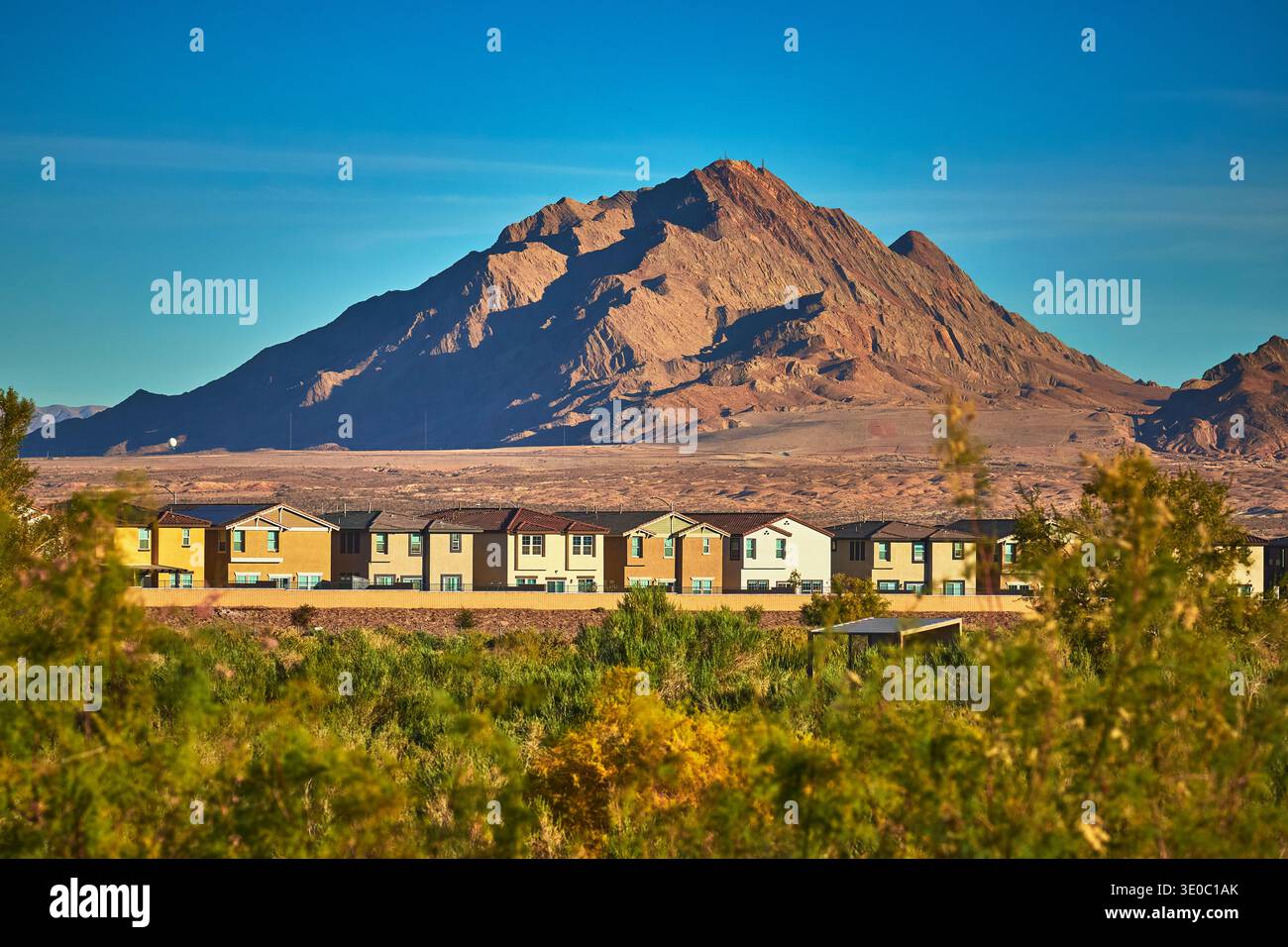 Desert Mountain Sunrise and Suburban Homes with Greenery in Henderson Nevada Stock Photo