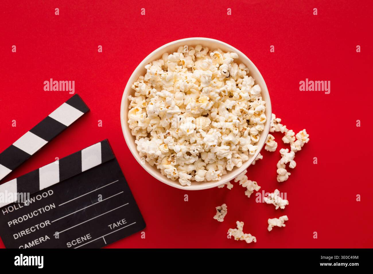 Clapperboard popcorn on red background Stock Photo