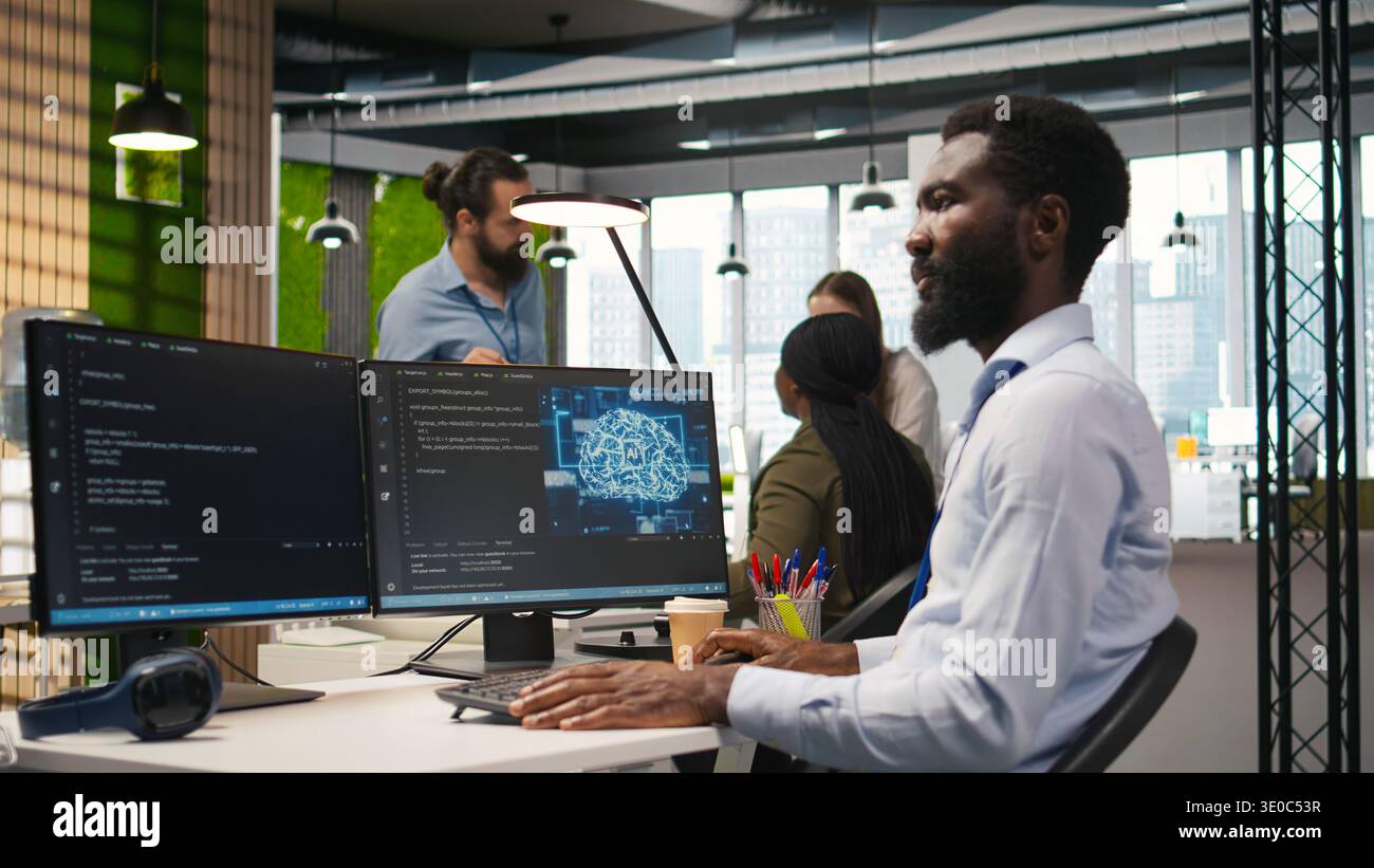 Computer scientist using AI on computer to optimize performance and forecast issues. African american worker in office training machine learning models using PC, camera A Stock Photo