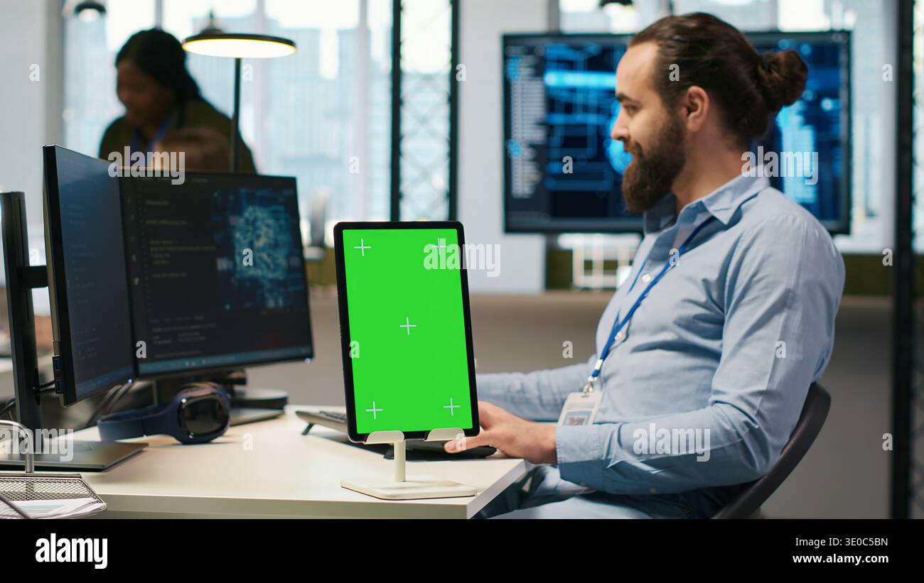 Startup technician using isolated screen tablet, developing artificial intelligence models for business analytics. IT expert using chroma key device, running simulations for AI forecasting, camera A Stock Photo