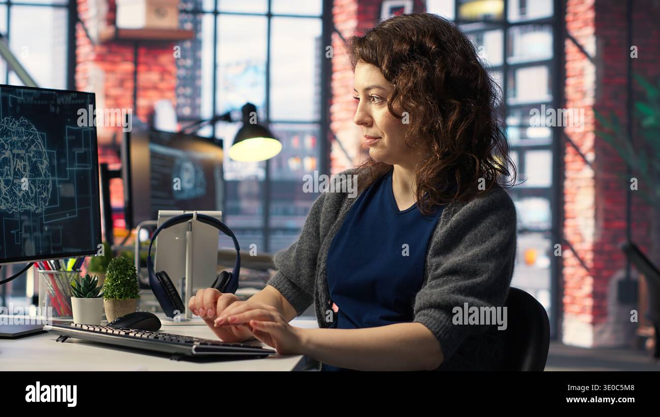 IT expert writing code and debugging on artificial intelligence neural networks computerized brain model. Woman tech support doing checkup on AI systems, cloud computing. Camera B. Stock Photo