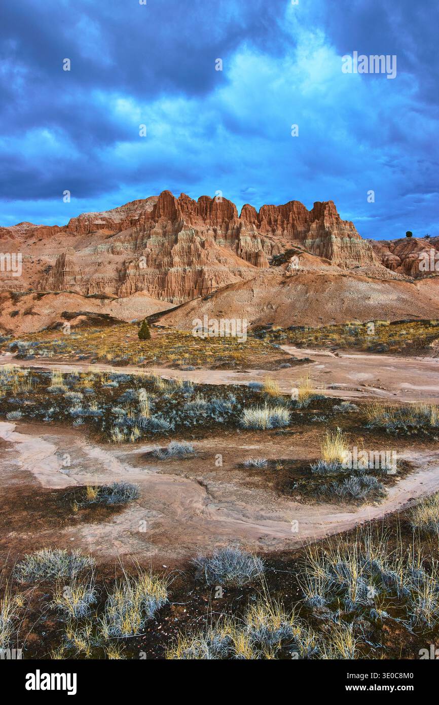 Cathedral Gorge State Park Dramatic Eroded Cliffs Desert Vegetation under Stormy Sky Stock Photo