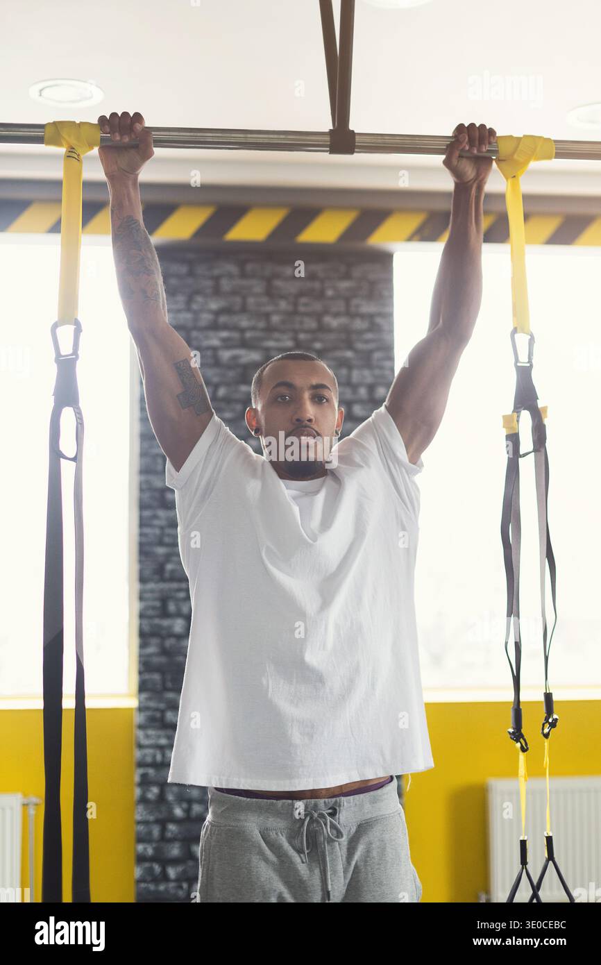Man doing pull up exercise on horizontal bar Stock Photo