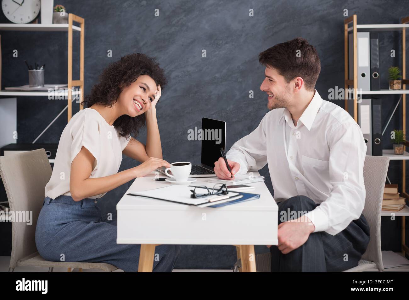 Business couple sitting and talking at modern office Stock Photo