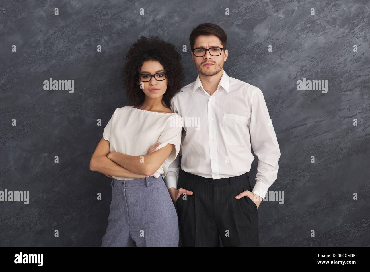 Confident business couple on gray background Stock Photo