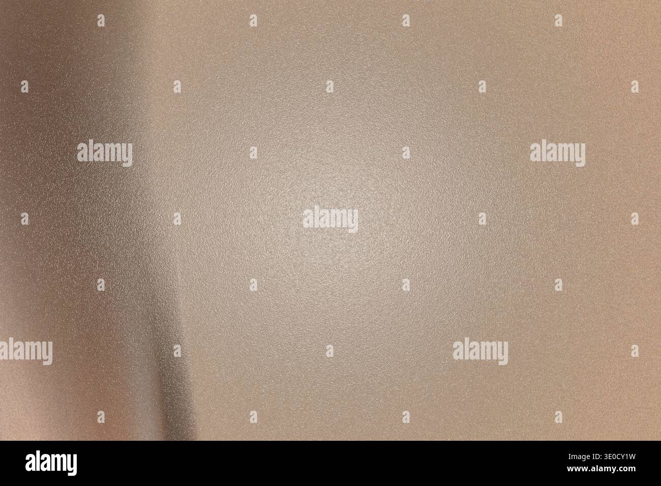 A slightly out-of-focus image showing a beige wall with a subtle gradient and texture. The lighting is uneven, creating a soft, muted effect. Stock Photo