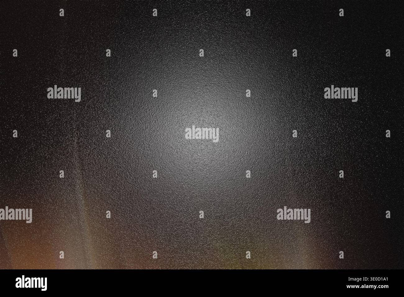 A dark abstract image featuring a bright, central glow surrounded by subtle radial light streaks and a textured, dark background. The overall effect i Stock Photo