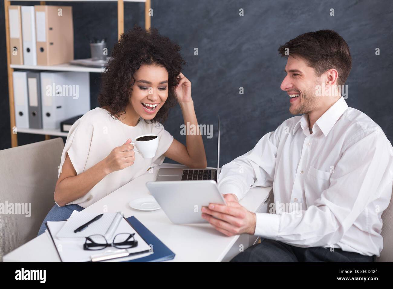 Businesspeople using digital tablet and drinking coffee Stock Photo