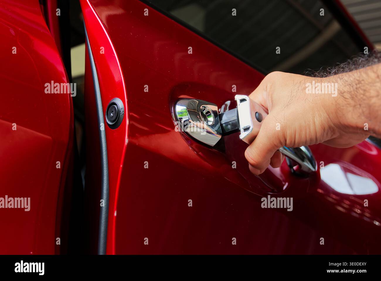 Premium Car Entry Premium Car Door Access, A hand opens the chrome handle of a sleek red ...
