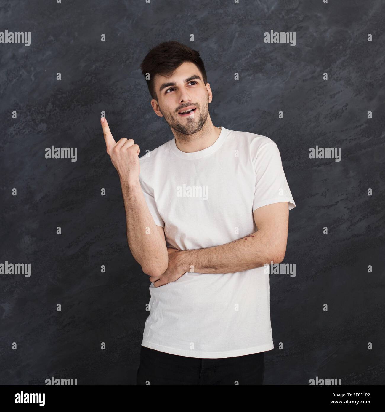 Man pointing up, making idea gesture Stock Photo