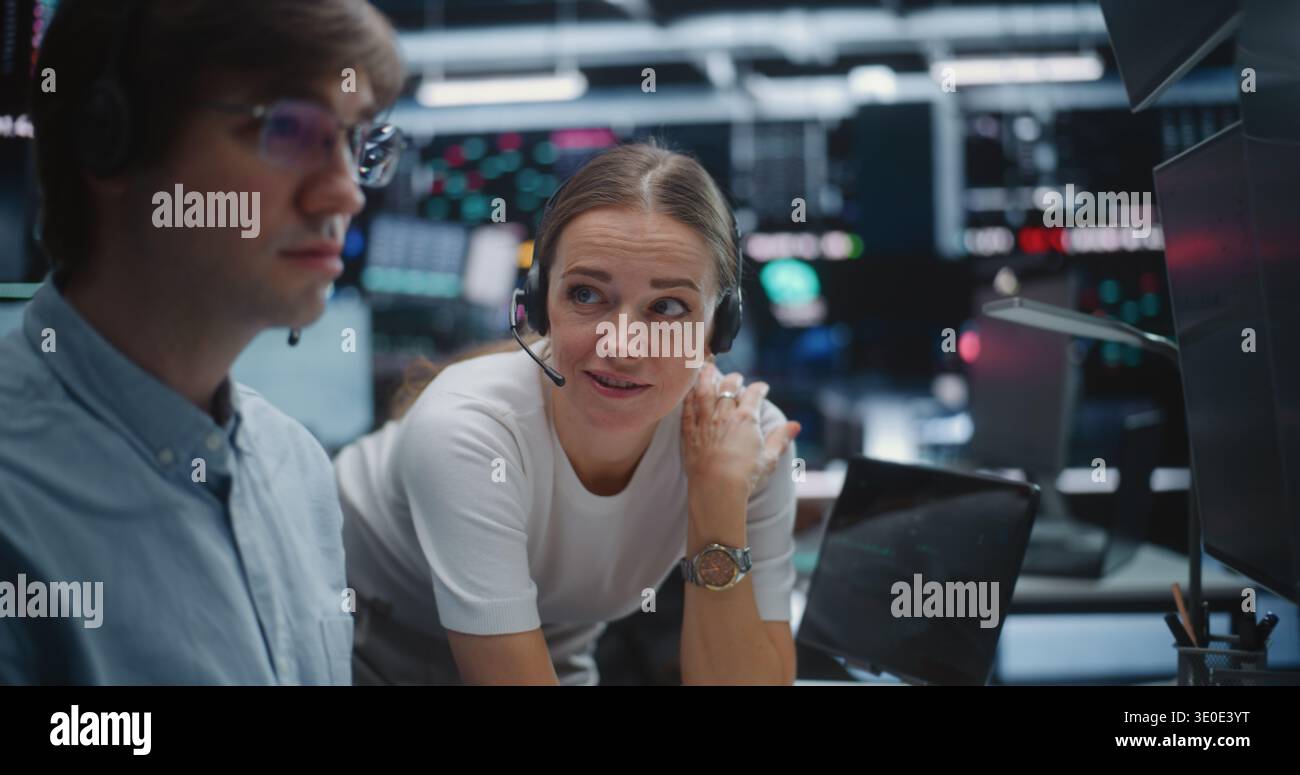 Male and Female Brokers Analyzing Real Time Stock Data Together. Two Professional Investment Experts Collaborate Closely on Trading Floor. Strategy Discussion, Data Driven Decision Making, Teamwork. Stock Photo