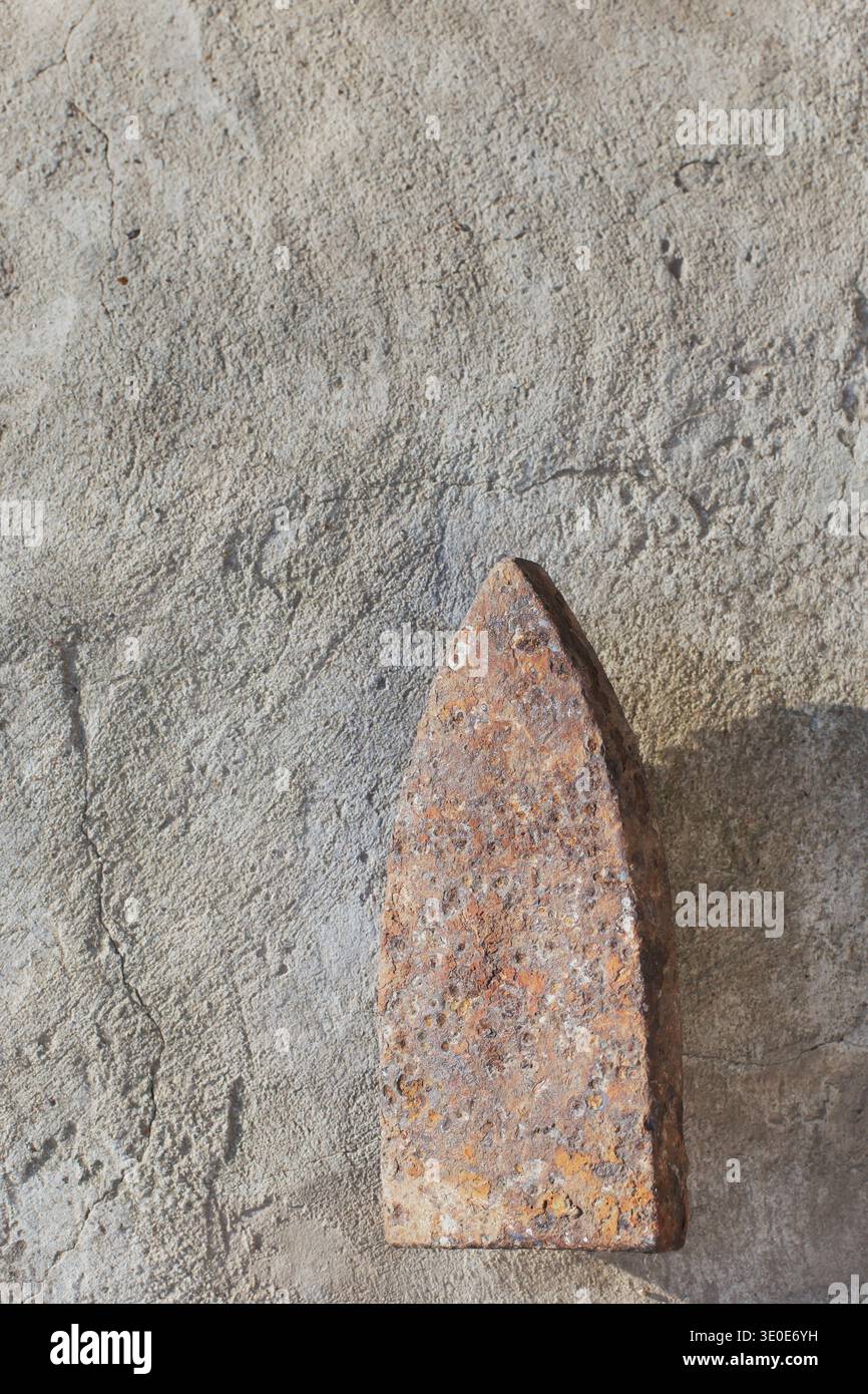 Old cast-iron flatiron soleplate with heavy rust texture, antique ironing tool. Stock Photo