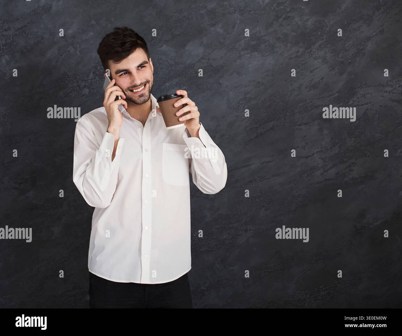 Excited man having pleasant conversation on smartphone Stock Photo