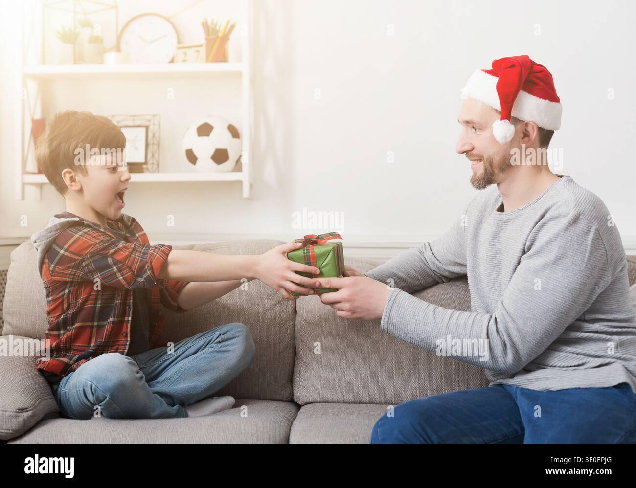Father giving his son a christmas present at home Stock Photo