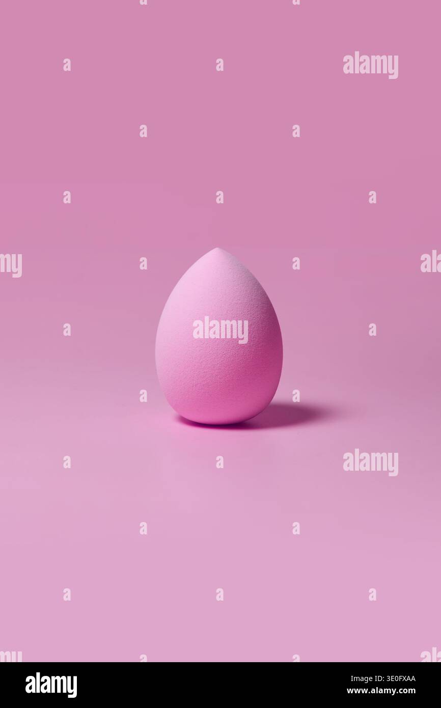 Pink makeup sponge on pastel pink background Stock Photo