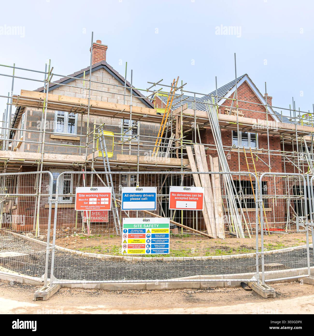 Housing construction site, part built homes covered in scaffolding and ...