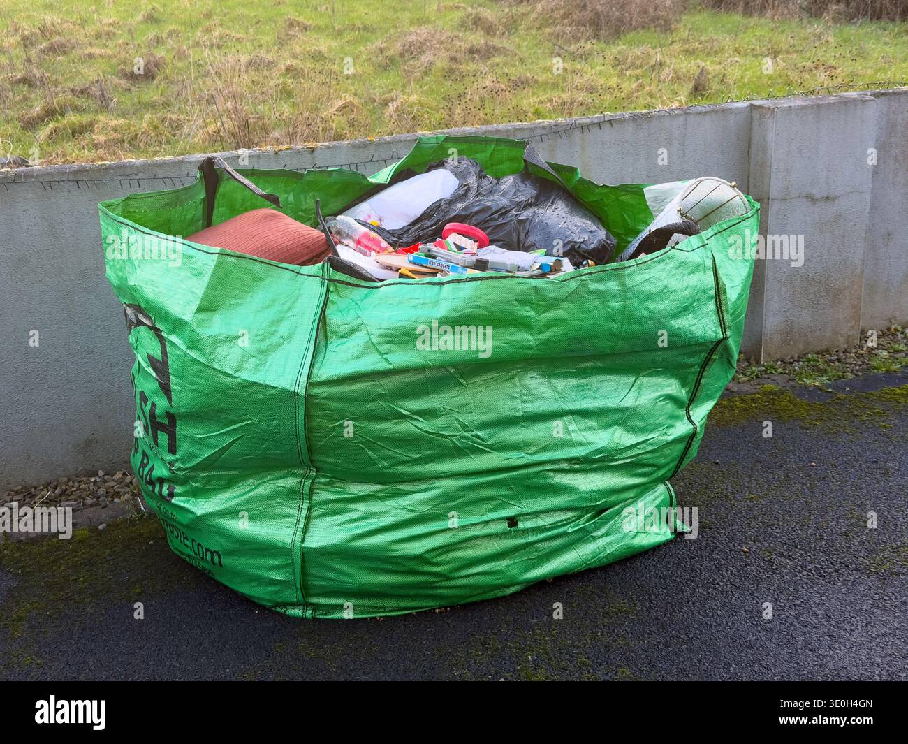A skip bag filled with rubbish, waiting for collection, a handy way to dispose of awkward domestic things Stock Photo