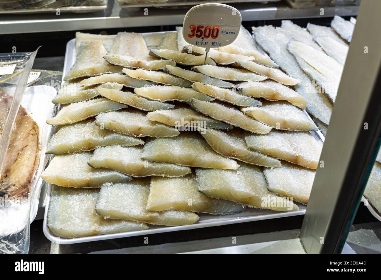 Layers of salt-cured cod fish pieces ready for sale at a traditional ...