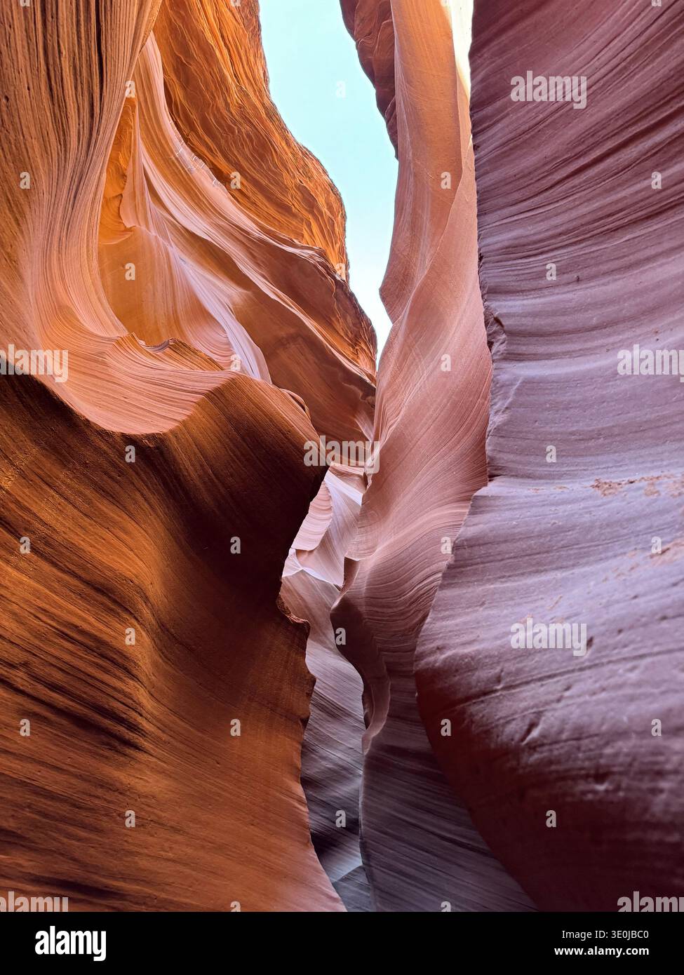 View from inside slot canyon with sculpted sandstone formations and sky visible through narrow opening in Arizona, USA. - Smartphone Captured Stock Image