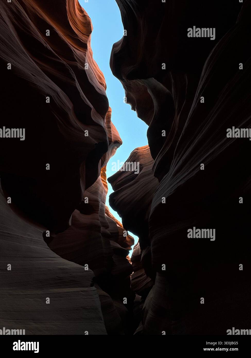 View from inside slot canyon with sculpted sandstone formations and sky visible through narrow opening in Arizona, USA. - Smartphone Captured Stock Image