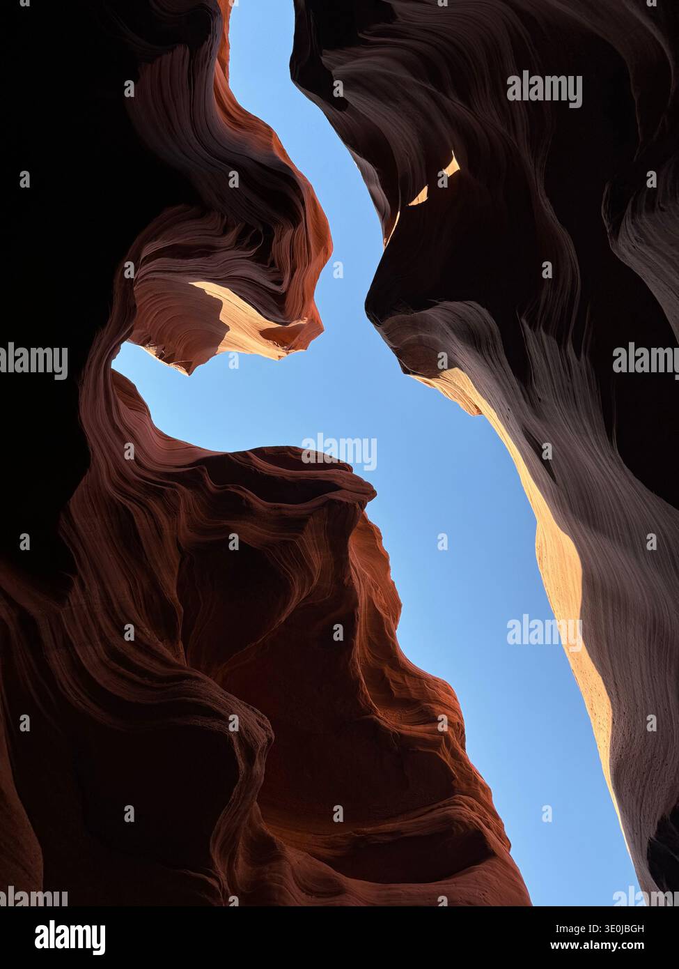 View from inside slot canyon with sculpted sandstone formations and sky visible through narrow opening in Arizona, USA. - Smartphone Captured Stock Image