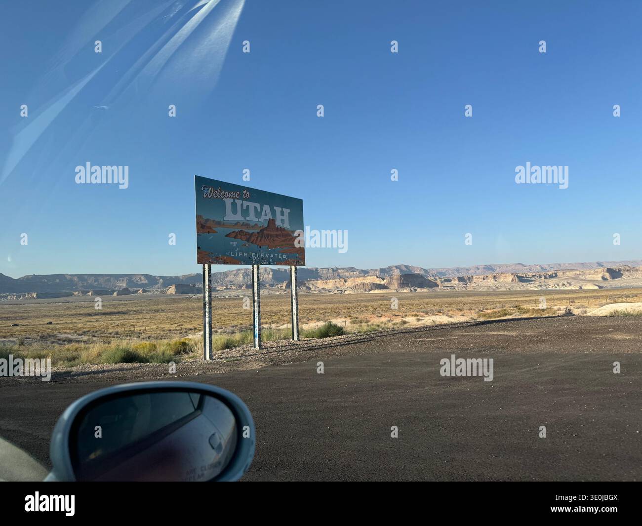 Welcome to Utah road sign in desert landscape with sandstone hills and open highway in Southwest USA. - Smartphone Captured Stock Image