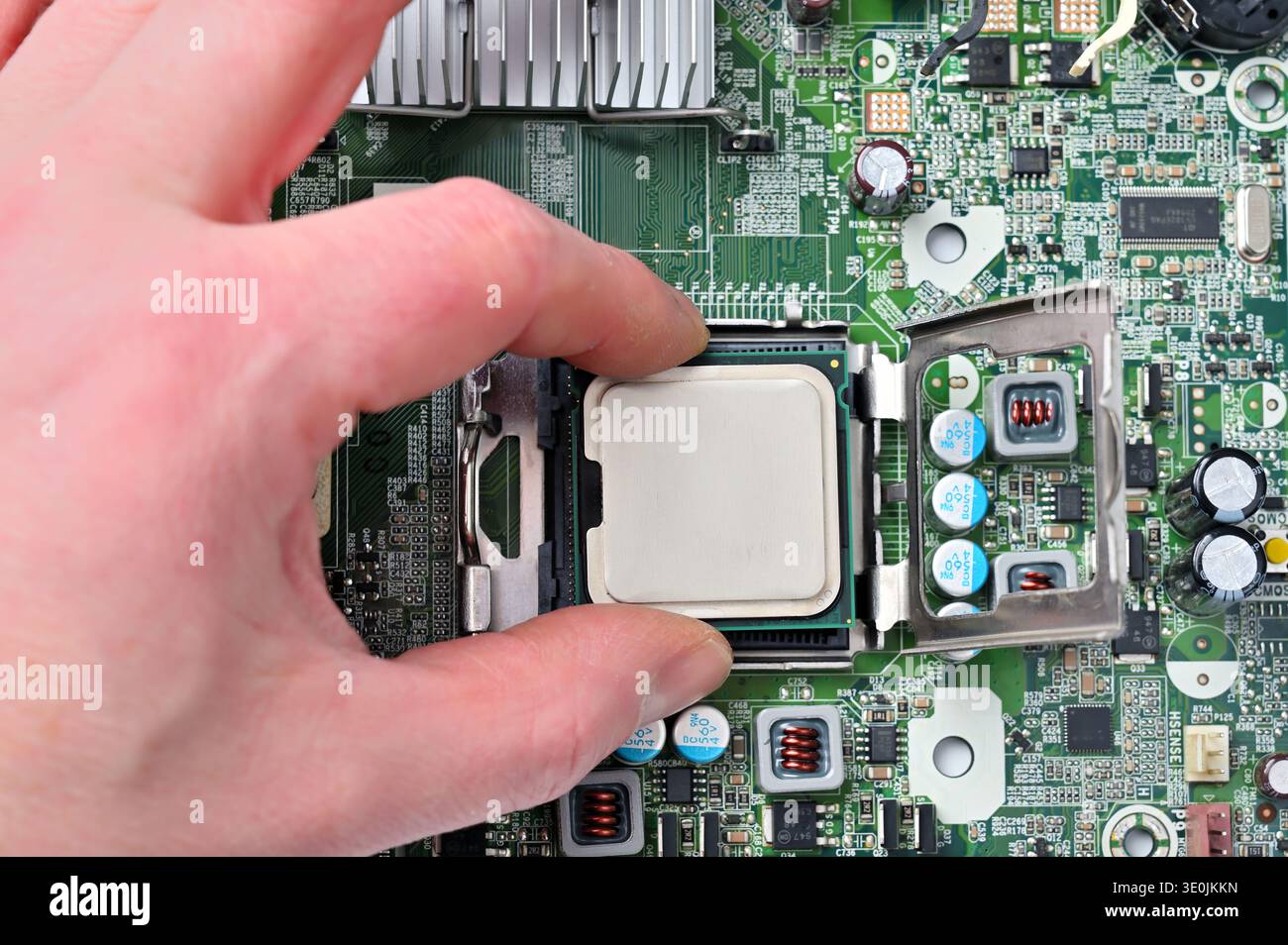 Installing a central processing unit into a computer motherboard socket for upgrade or repair Stock Photo