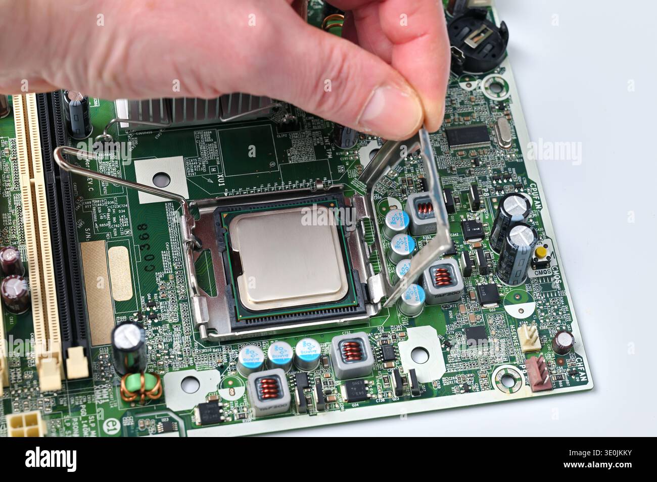 Installing a computer processor into the motherboard socket, close-up view Stock Photo