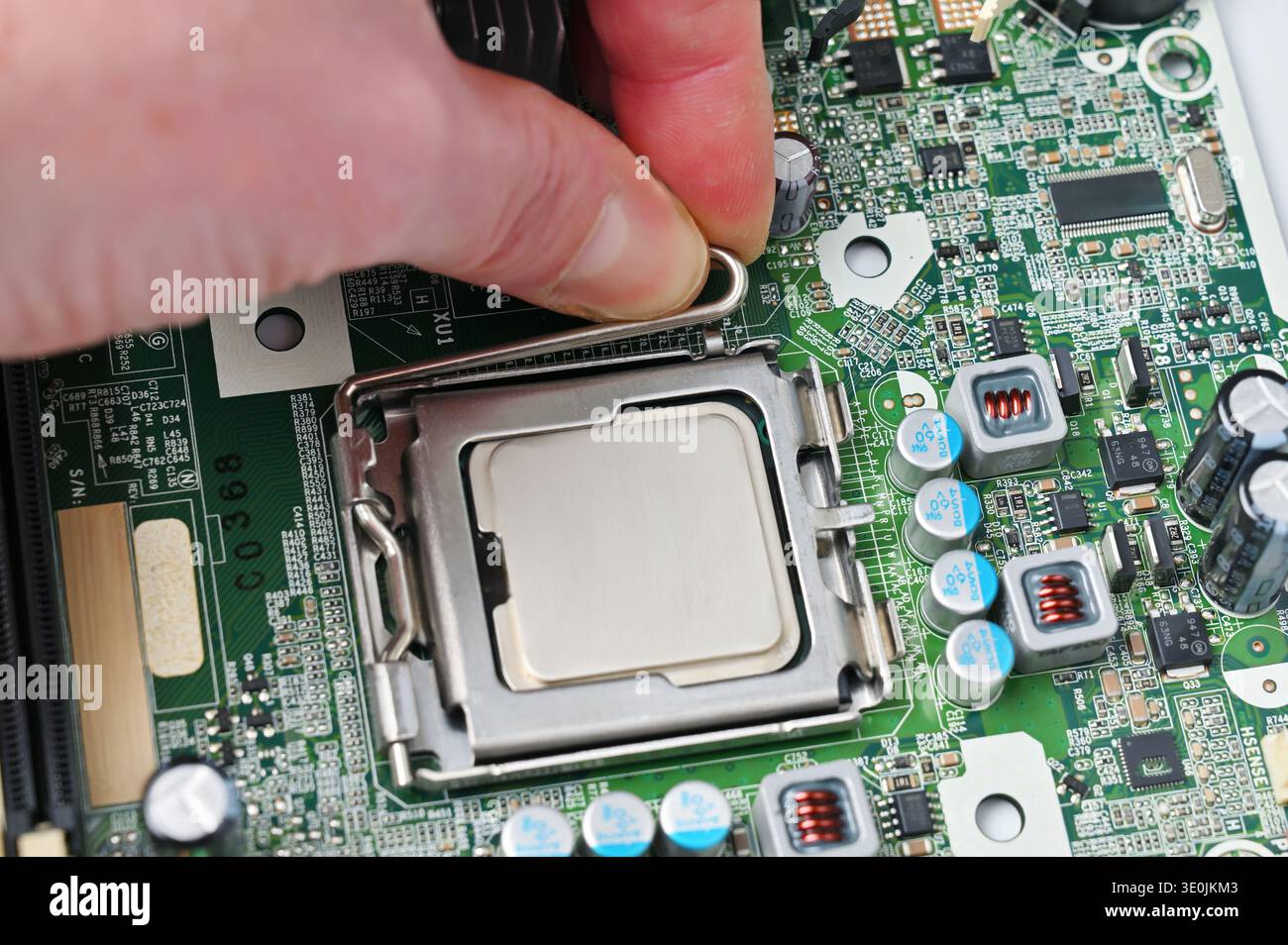 Installing a central processing unit into a computer motherboard socket for upgrades or repairs Stock Photo