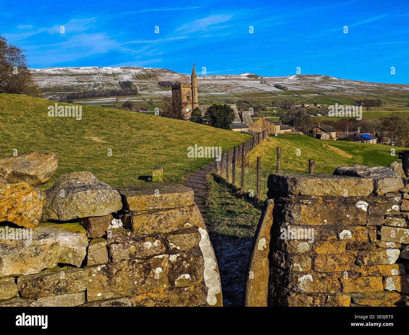 Footpath to Hawes, Wensleydale, North Yorkshire. A narrow stile and flagstone footpath leads to the market town of Hawes in the Yorkshire Dales. - Smartphone Captured Stock Image