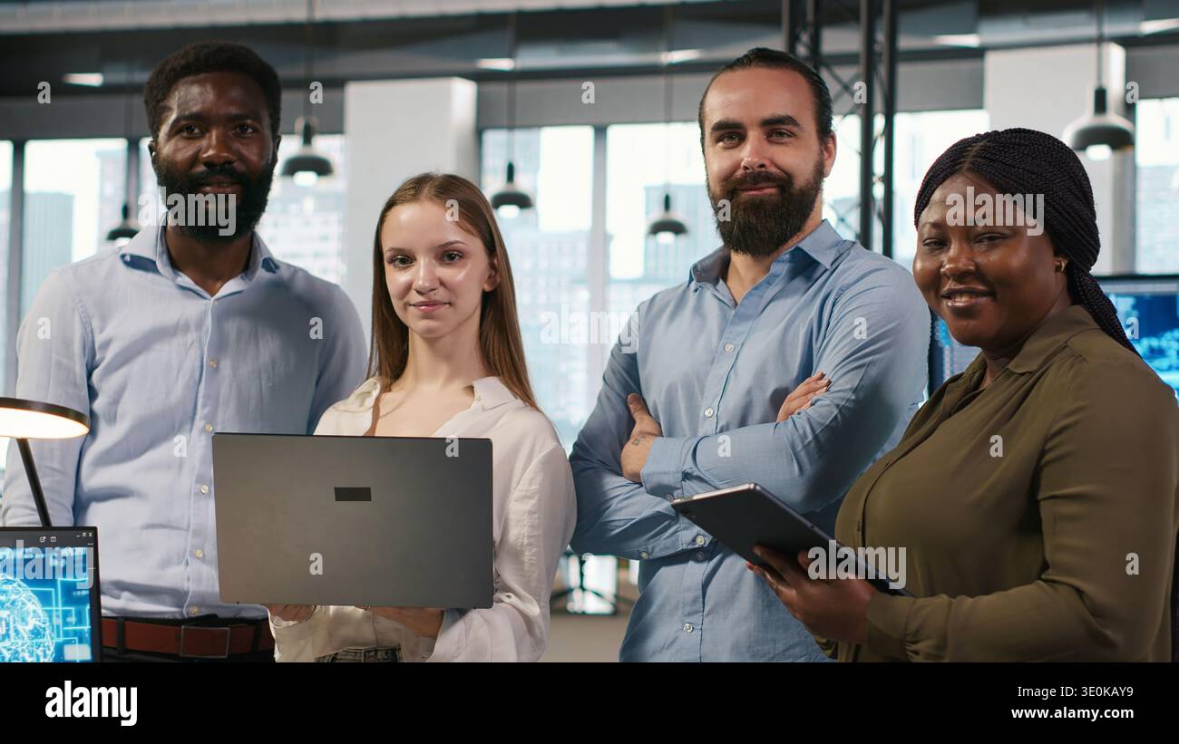 Portrait of happy teamworking engineers writing code, developing machine learning APIs. Team of smiling IT experts troubleshooting software errors using artificial intelligence, camera A Stock Photo