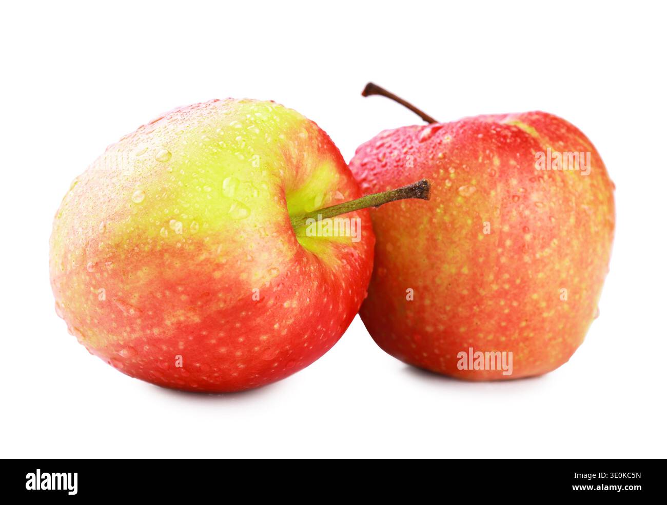 Two fresh, crisp red apples covered in water droplets, isolated on a white background. Perfect for healthy eating, nutrition, and fresh produce concep Stock Photo