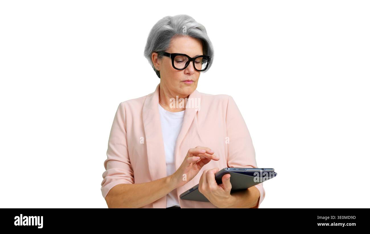 Senior businesswoman using digital tablet on white background Stock Photo