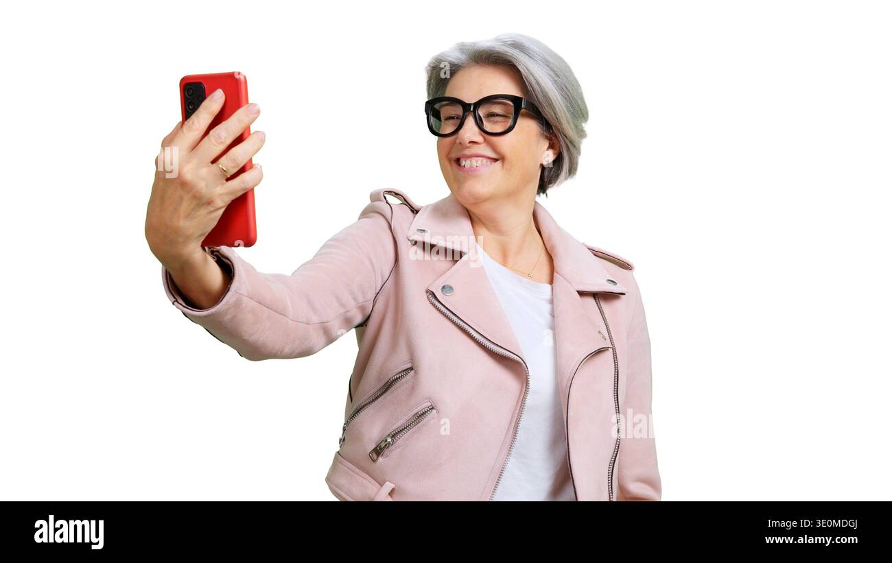 Senior woman using smartphone taking happy selfie Stock Photo
