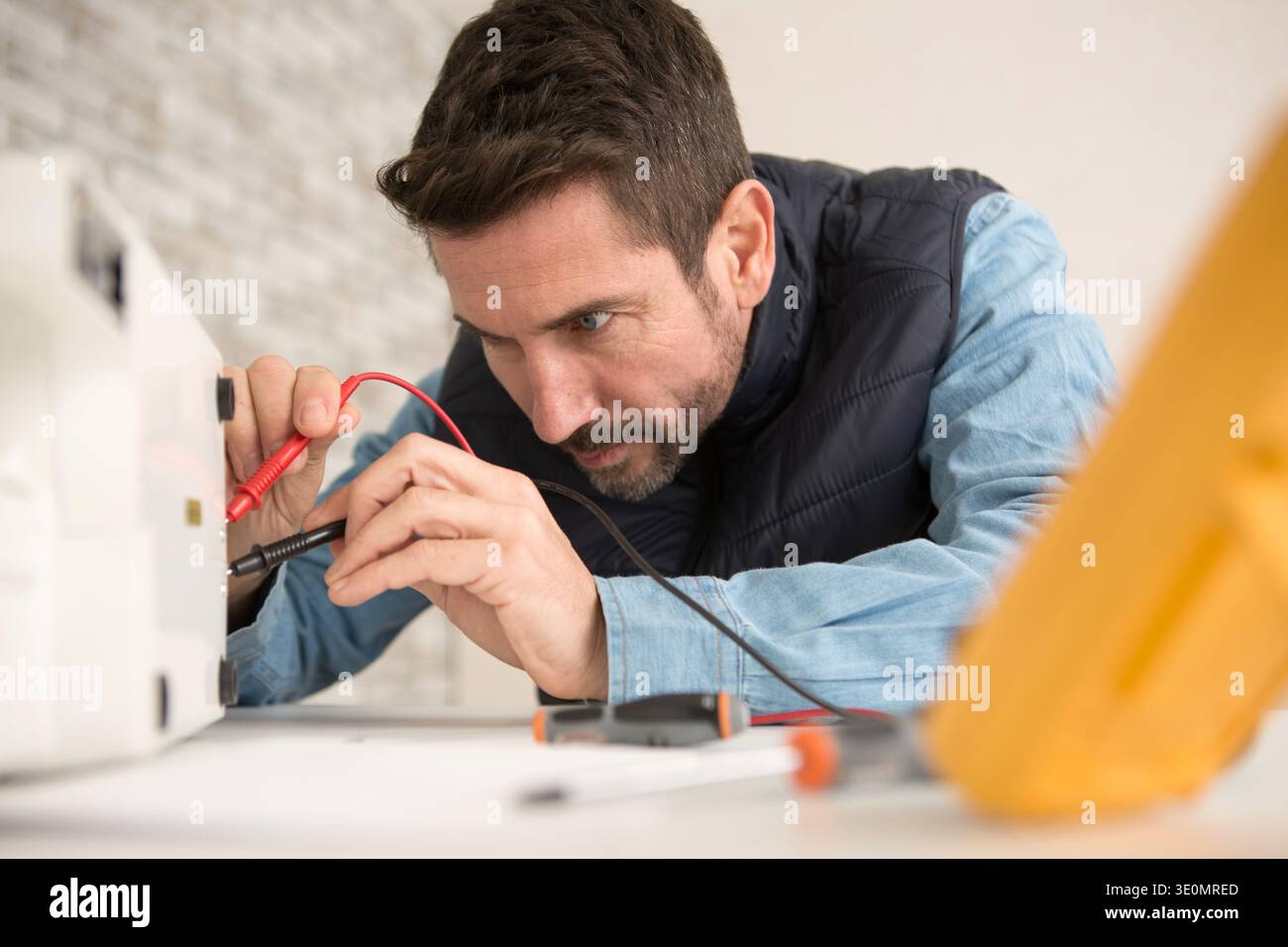 engineer using a voltage and current tester Stock Photo