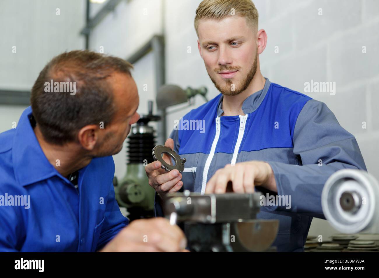 two steel workers checking machine Stock Photo