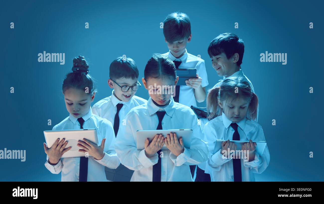 Children using tablets on studio background Stock Photo