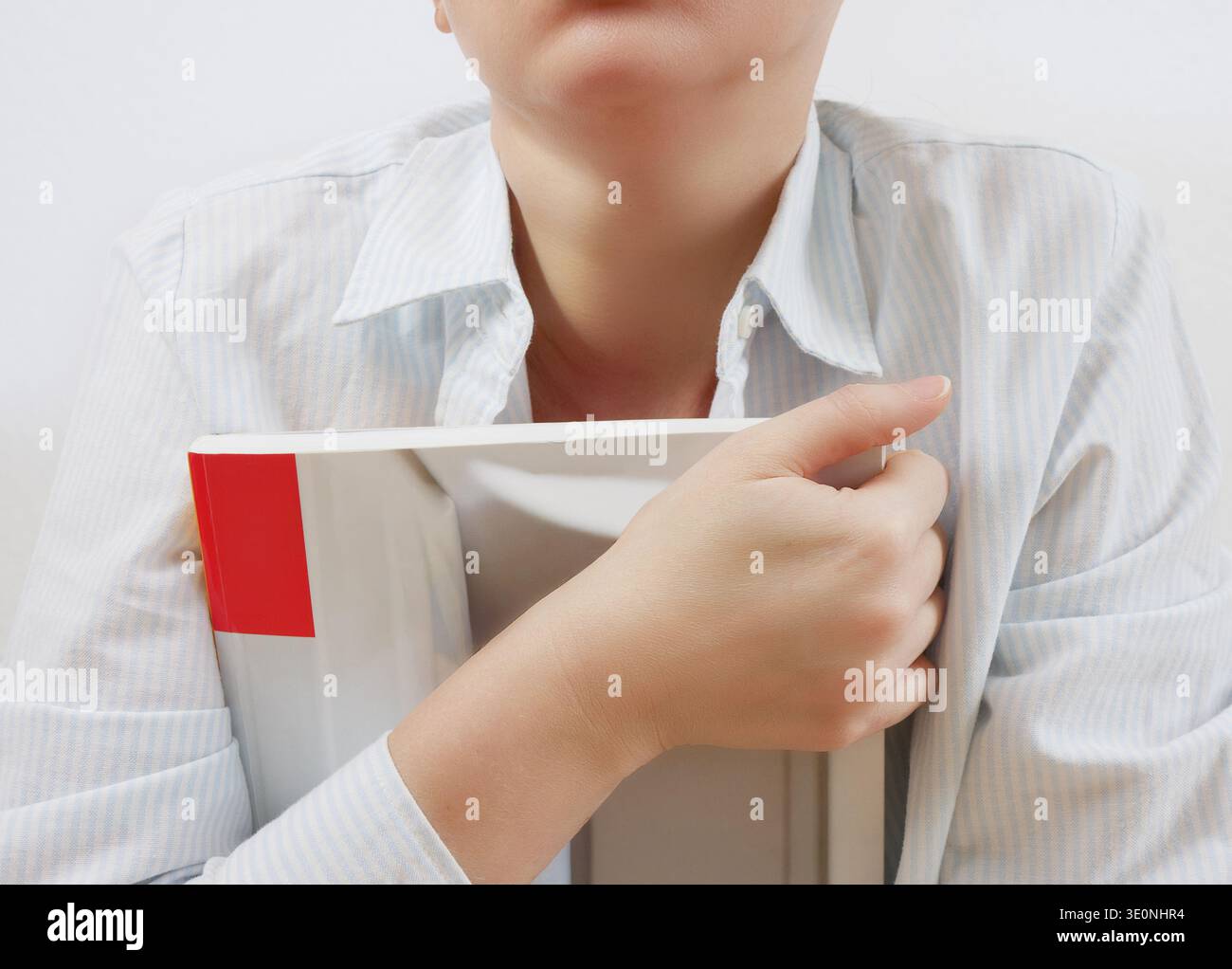 Student holding book isolated on white background Stock Photo