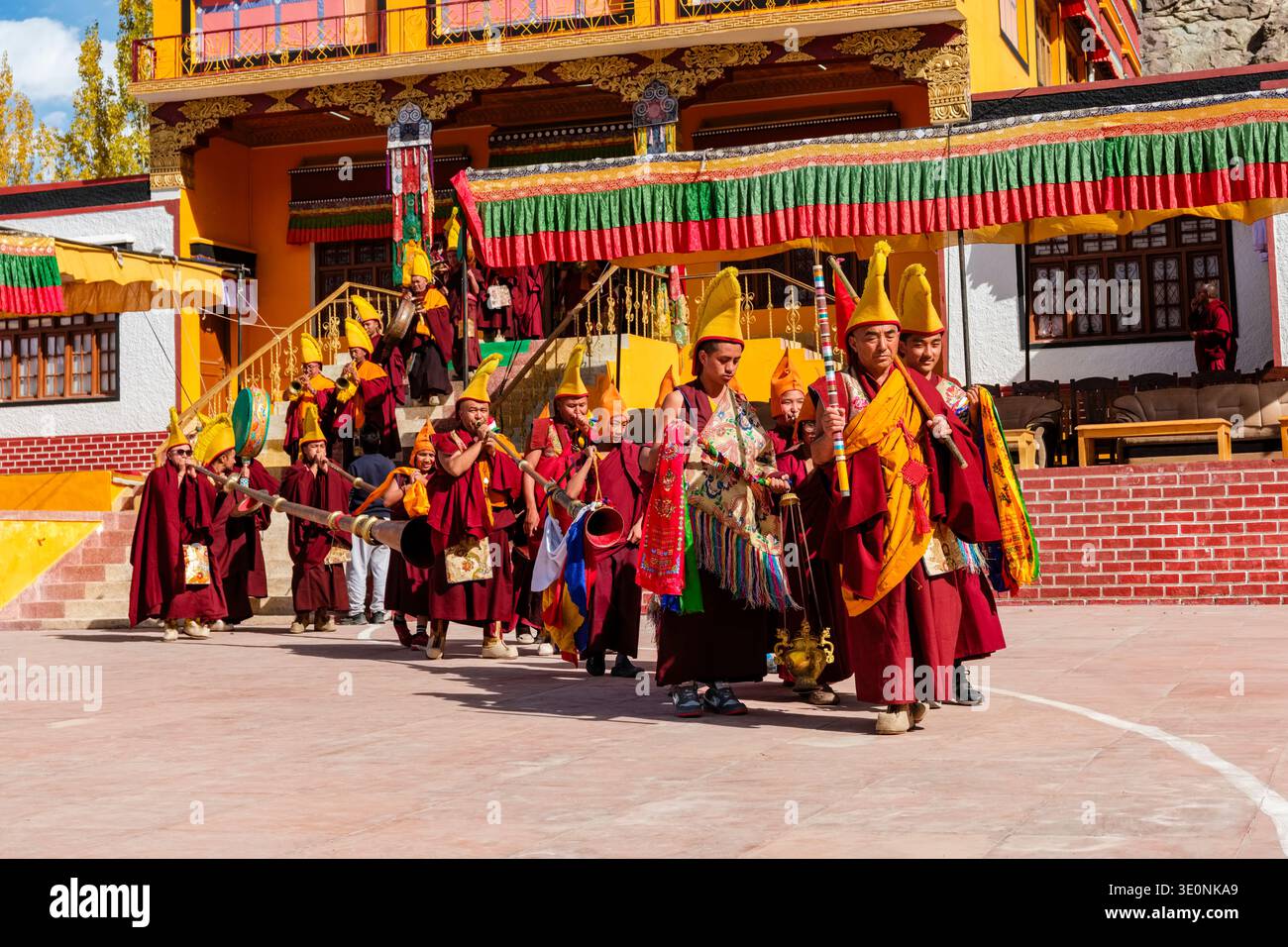 Yellow Hat Gelugpa monks lead a ceremonial procession with traditional music during the Diskit Gustor festival at New Diskit Gompa. Stock Photo
