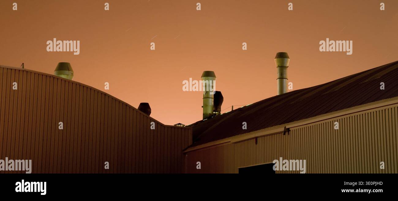 Factory Building Rooftops Factory rooftops with ventilation chimneys silhouetted against an ...