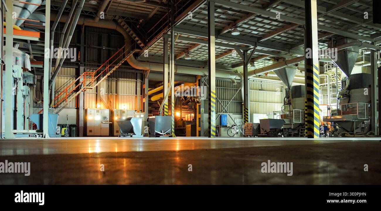 Wide view of a modern industrial factory interior with large machinery ...