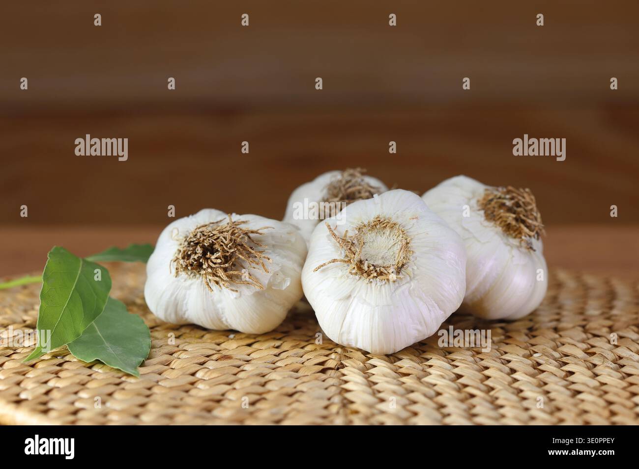garlic bulbs (heads) on kitchen bench. Stock Photo