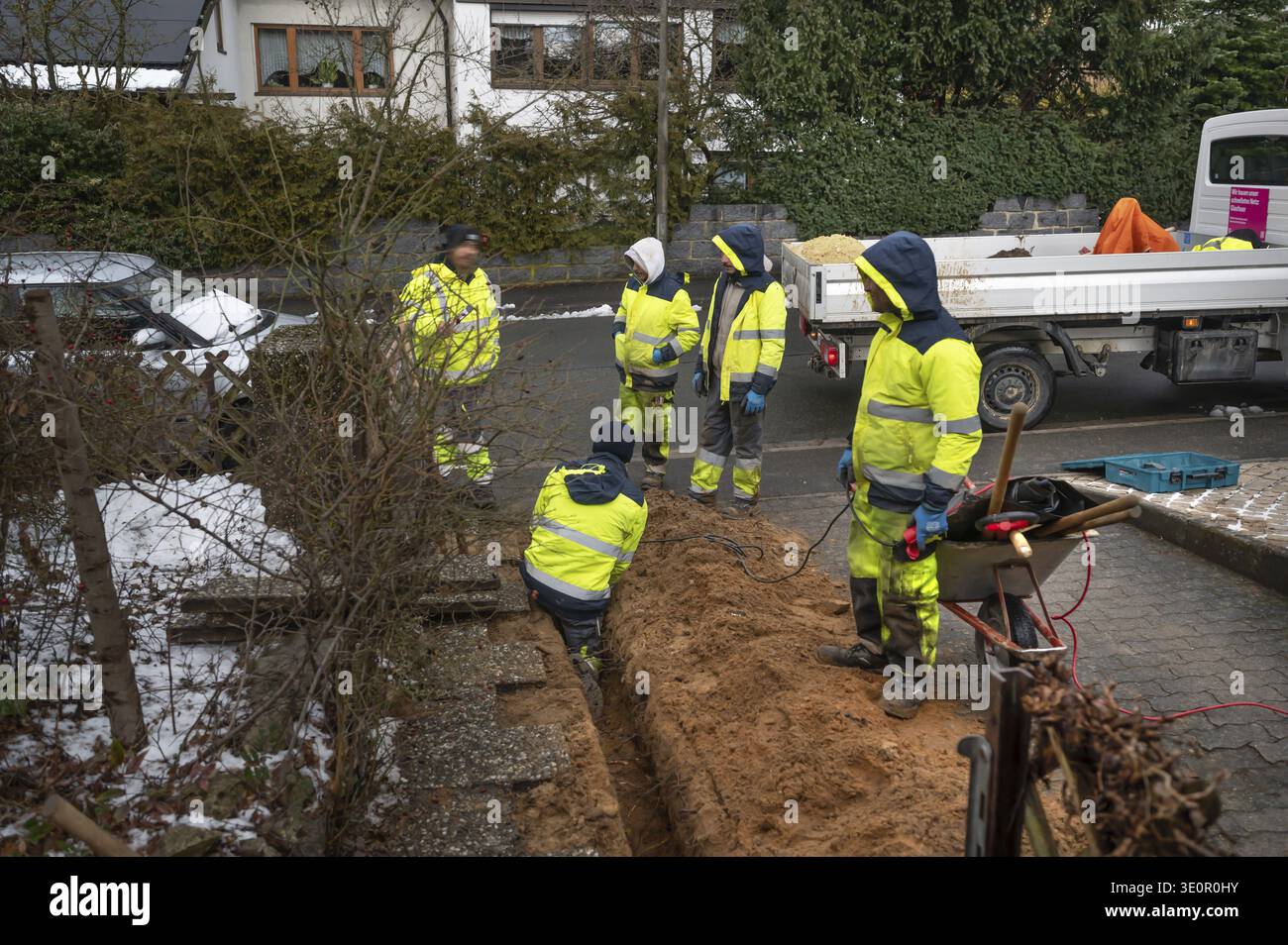 Construction crew laying Telekom fiber optic cables in a residential building, Eckental, Middle Franconia, Bavaria, Germany Stock Photo