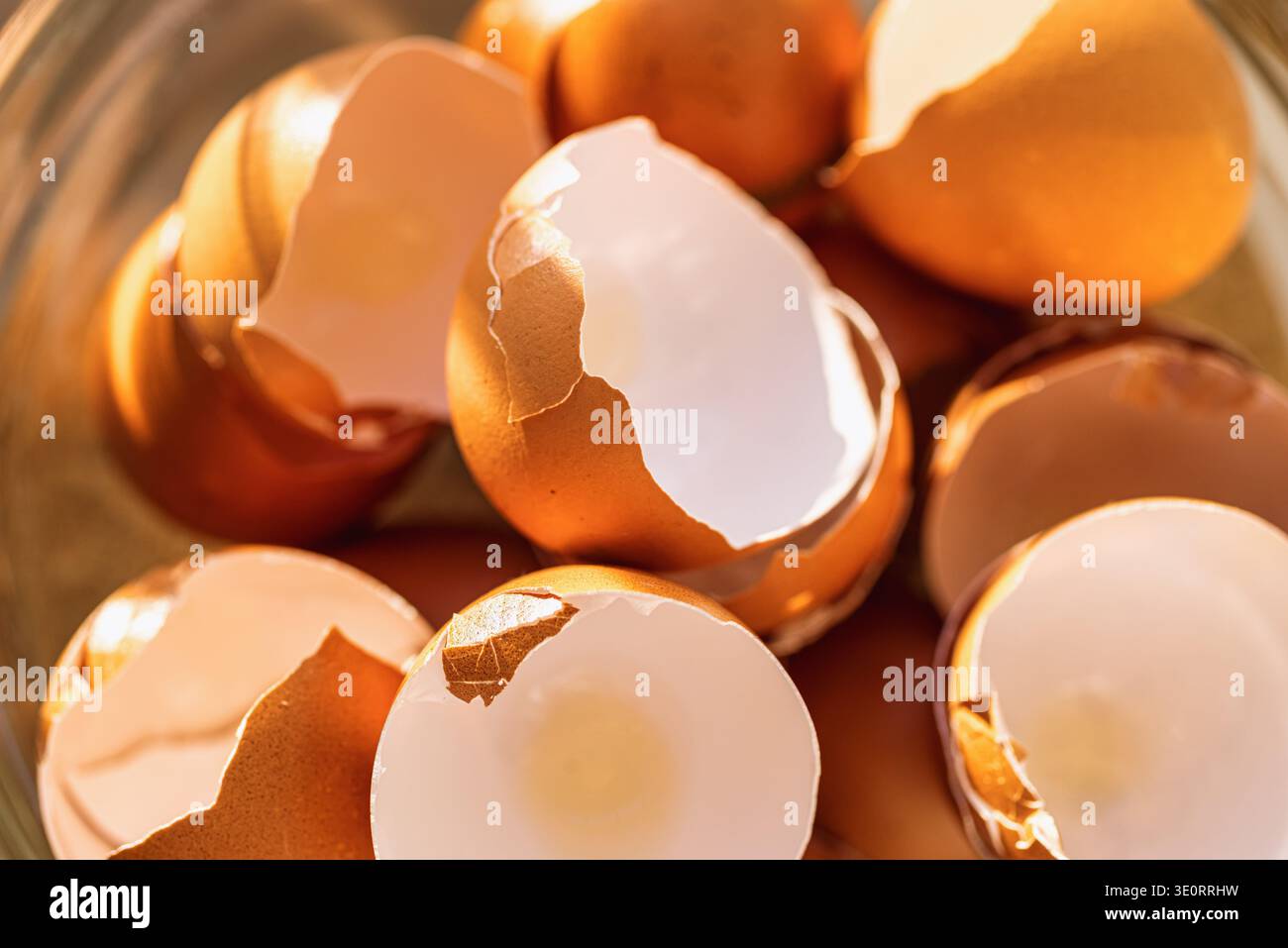 Empty cracked brown eggshells in a glass bowl Stock Photo